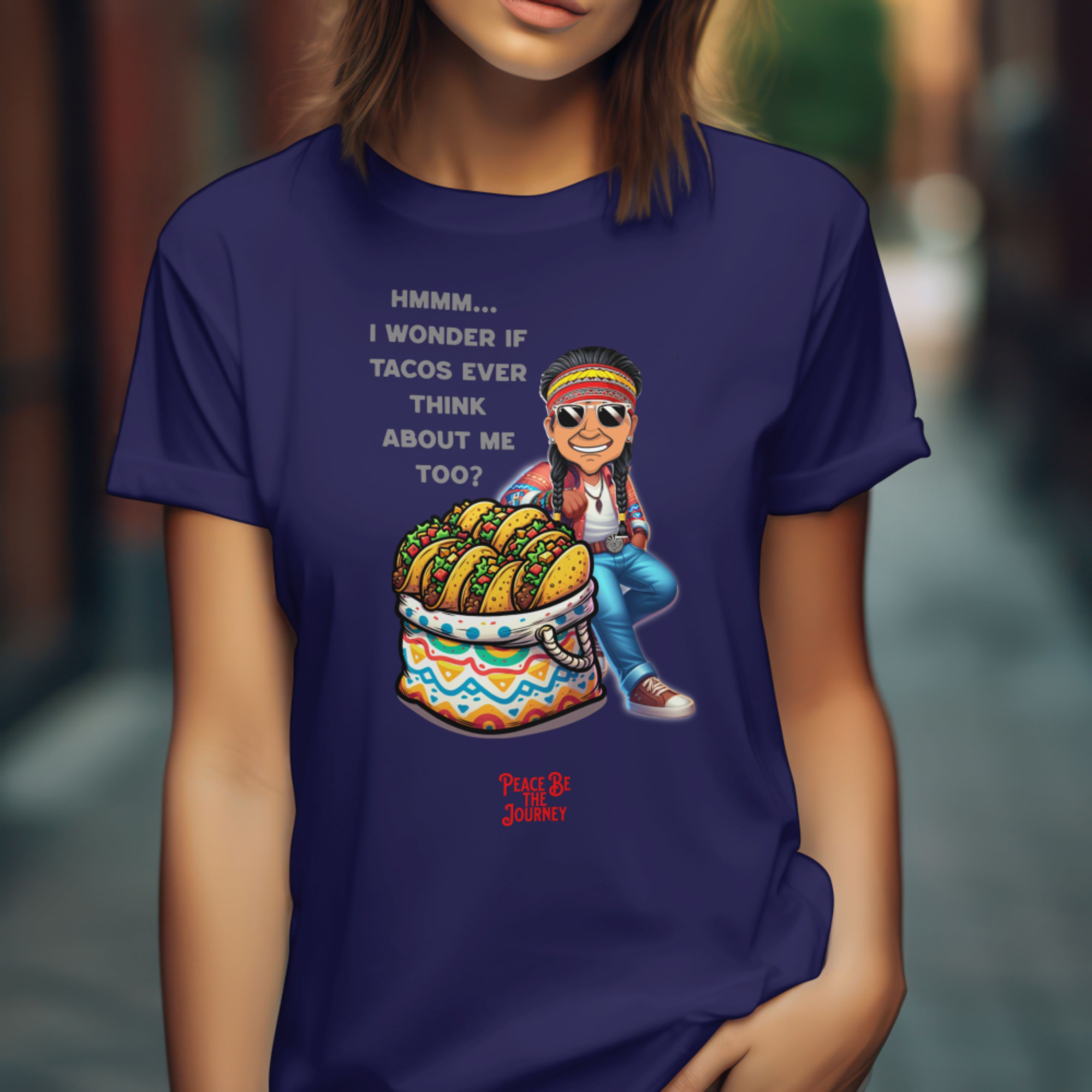 Person wearing a blue t-shirt with a graphic design of a person sitting on a taco-shaped stool.
